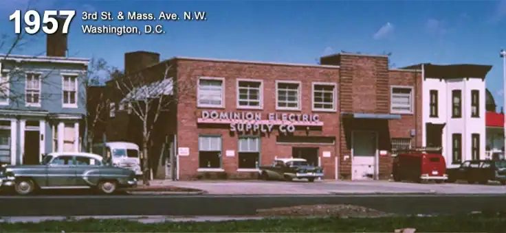 Nuestra historia 3 A brick building labeled "Dominion Electric Supply Co," an Electrical Distribution Company, with parked cars in front, located on 3rd St. & Mass. Ave. N.W., Washington, D.C., in 1957.